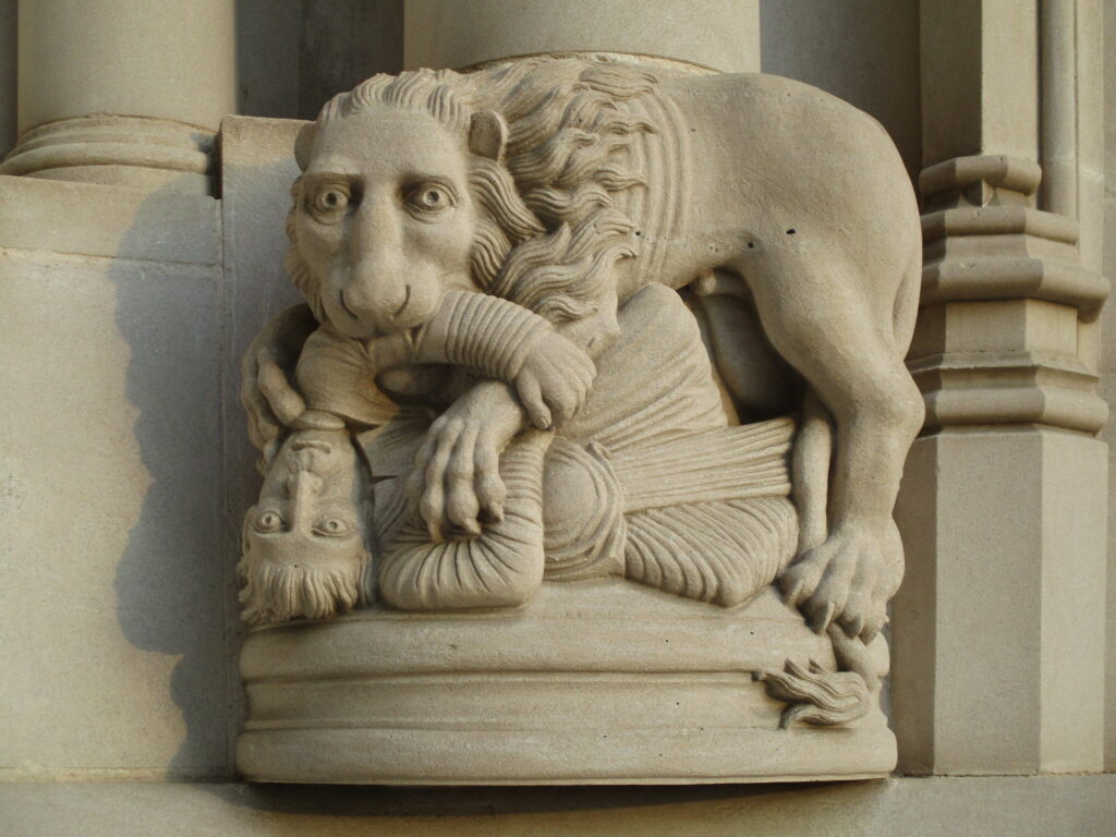 Lion eating an unfortunate Gothic figure