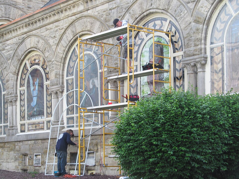 Workmen restoring stained glass