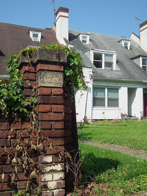Brick gatepost with number 378 and a half