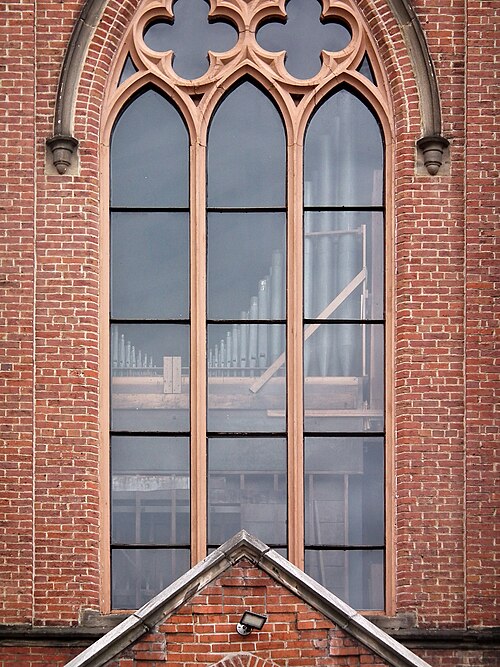 Clear window with organ pipes behind it