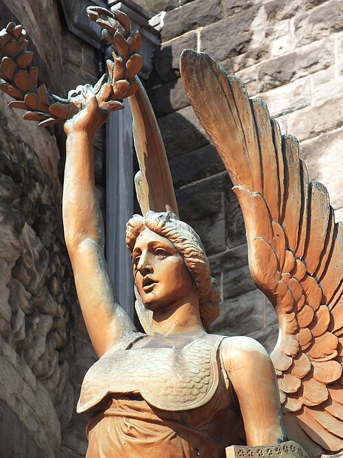 Victory holding up her wreath