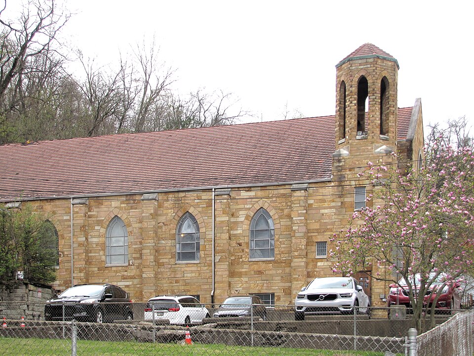 Parking lot with church behind it