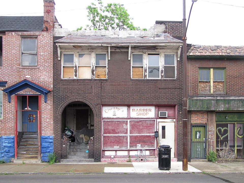 Commercial building with big arch at left entrance