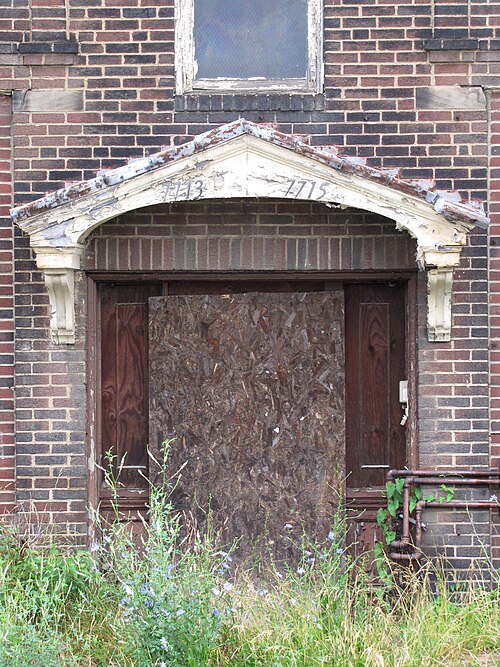 Front door of an abandoned apartment building on Frankstown Avenue in Brushton