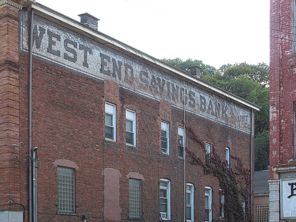 Painted sign reading “West End Savings Bank & Trust Co.”
