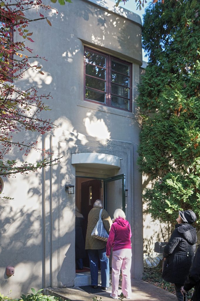 Front door of a house in Swan Acres, with people going in